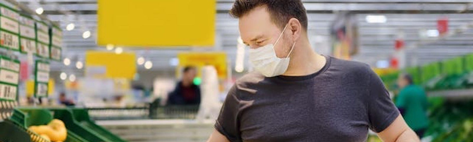 A customer shopping for produce at a supermarket.