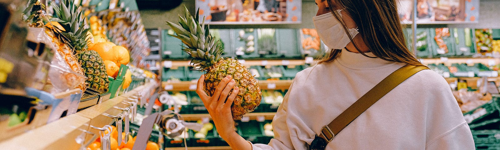 A woman masked up at the grocery store.