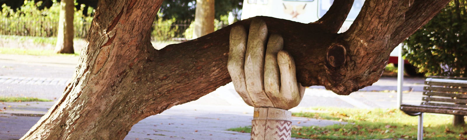 Tree supported by a large sculpted hand