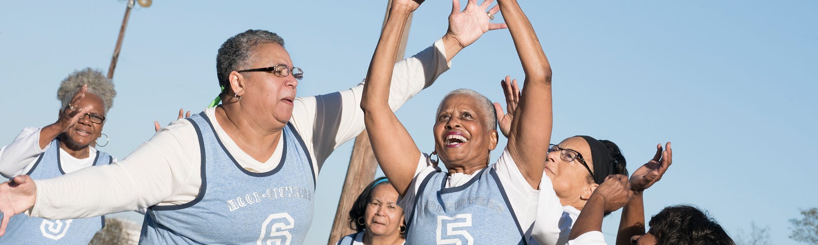 A group of senior women having fun and playing basketball.