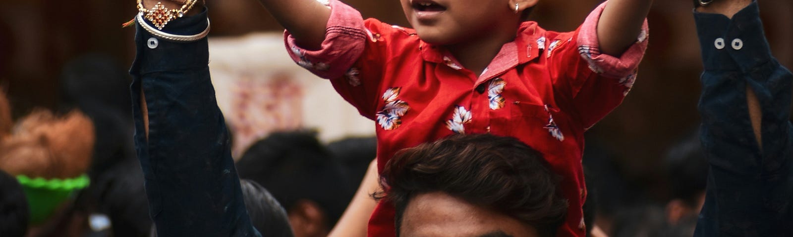 A man holding a child on his shoulders