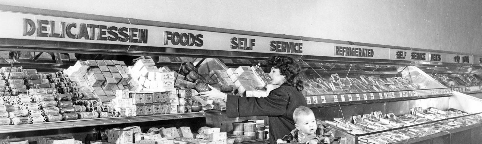 People picking up treats at a self-serve delicatessen in Bergs Supermarket, circa 1950.