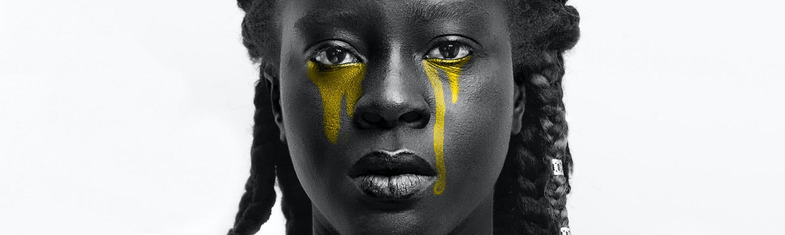 Greyscale portrait of a young Black woman with braids and tears of gold streaming down her face