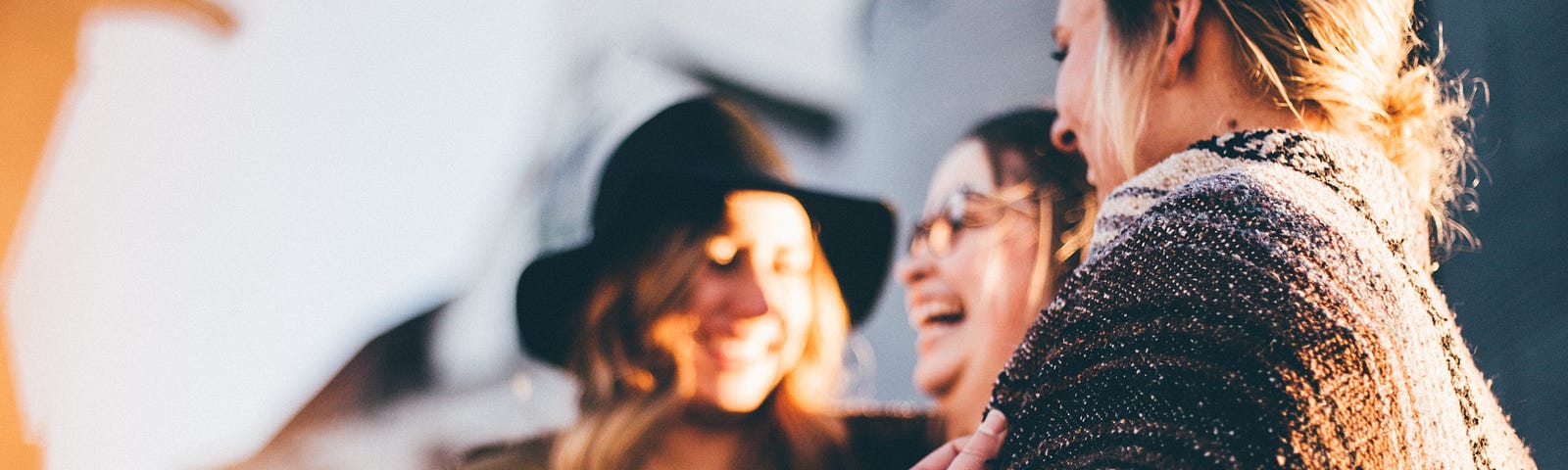 A group of three women laughing together.