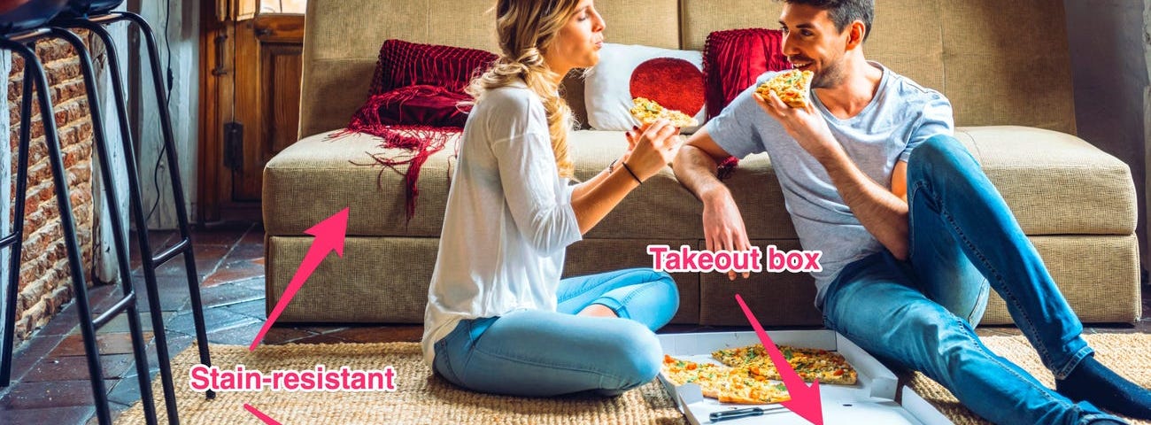 A couple eats pizza in a living room. A regular living room could have hidden sources of PFAS.