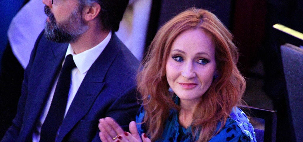 J.K. Rowling clapping at an event.