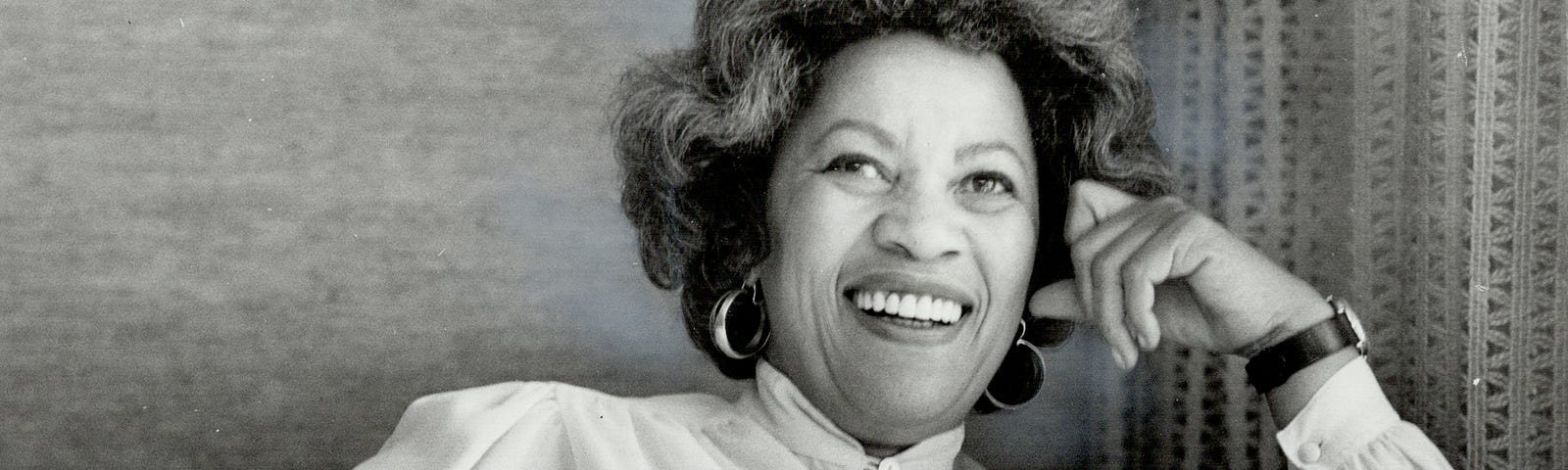 Black and white photo of Toni Morrison smiling.