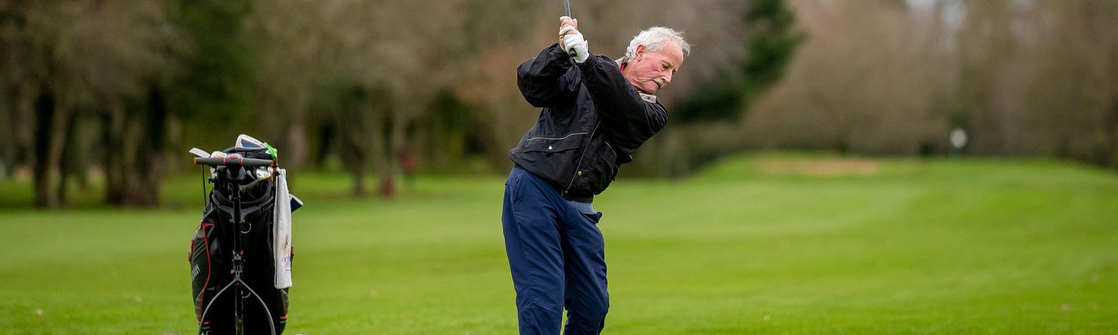 An older man playing golf.