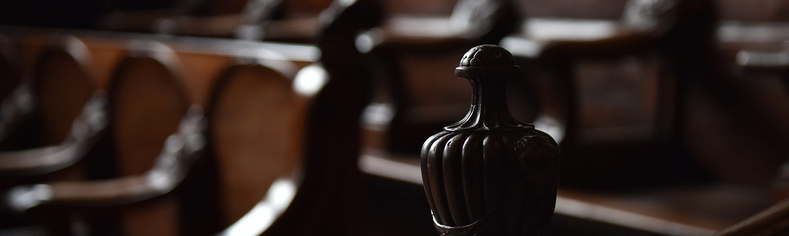 A photo of wooden pews in a courthouse.