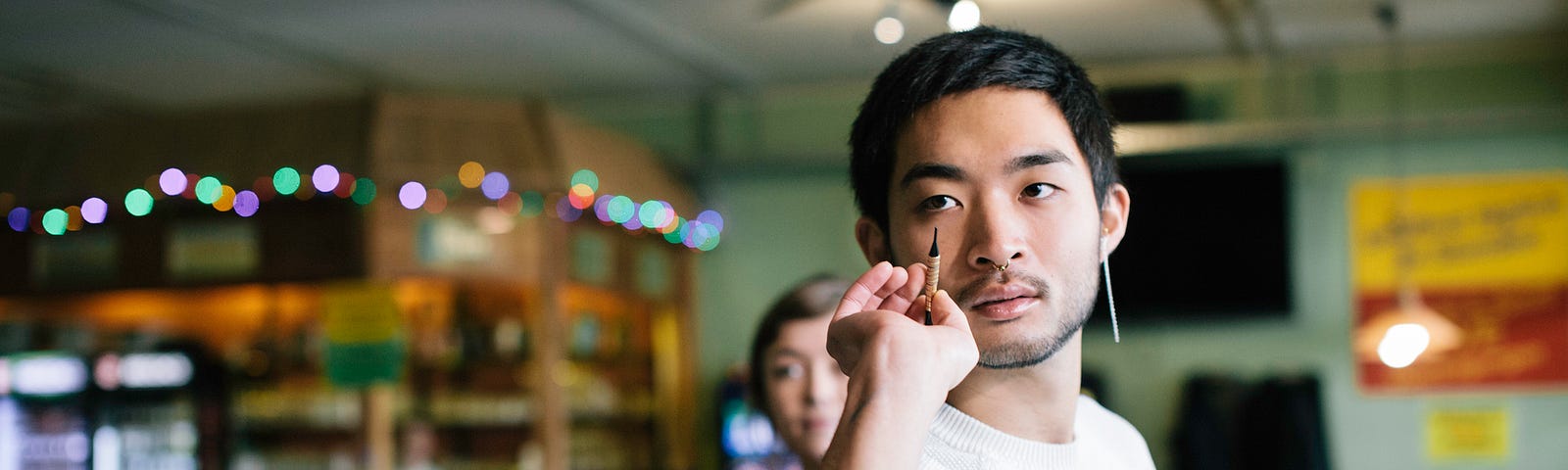 A man prepares to throw a dart with a focused expression.