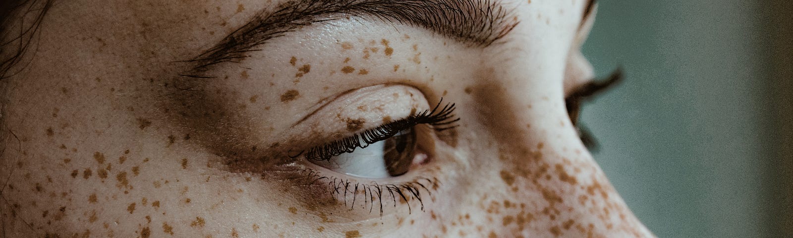 Closeup of woman’s face with freckles.