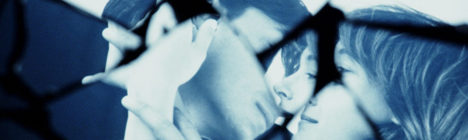 Shattered glass image of a man and woman about to kiss.