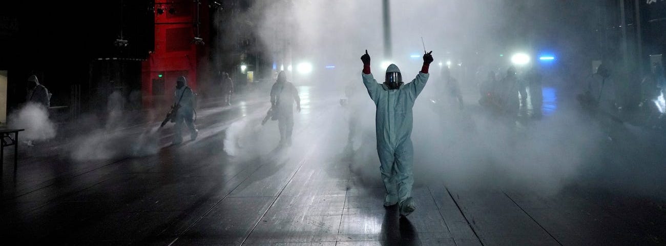 Volunteers disinfecting a theater in Wuhan, China.