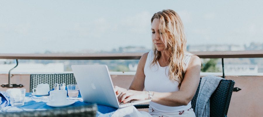 Lady working outside on her laptop