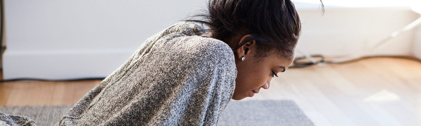 Young Black woman looking at her phone.