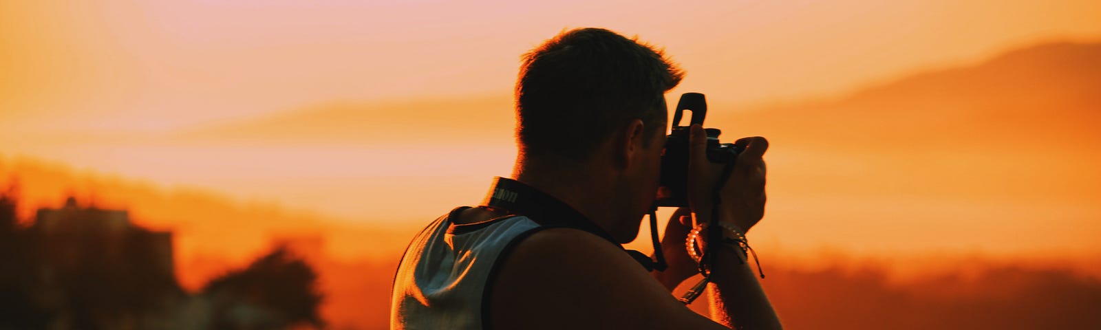 A photographer making an image of a sunset.