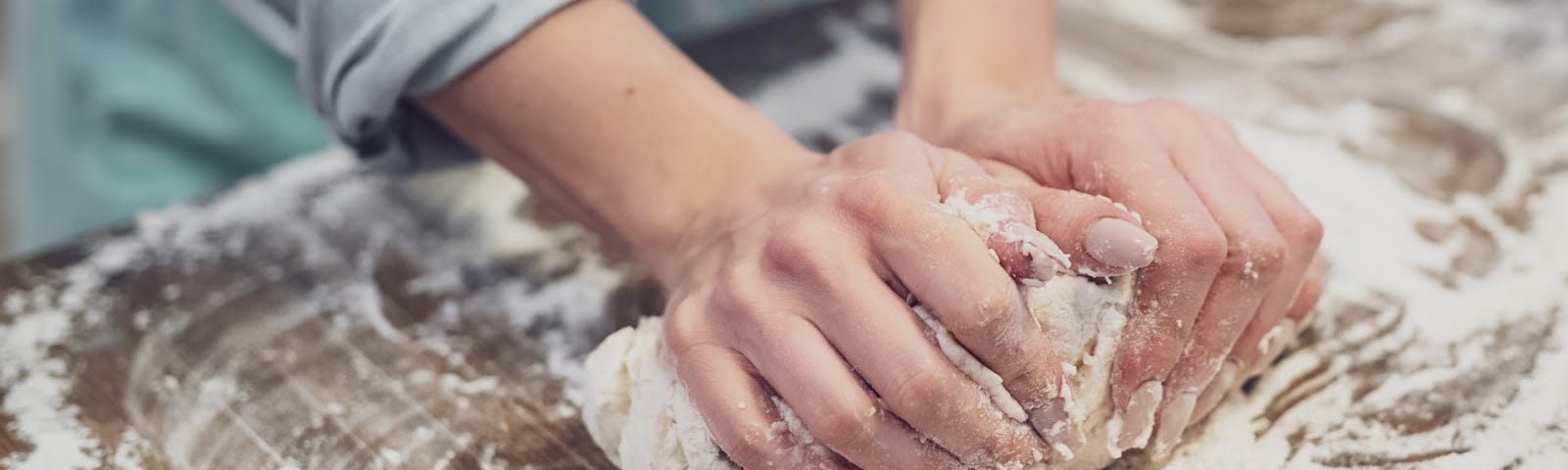 A photo of someone kneading bread/flour.