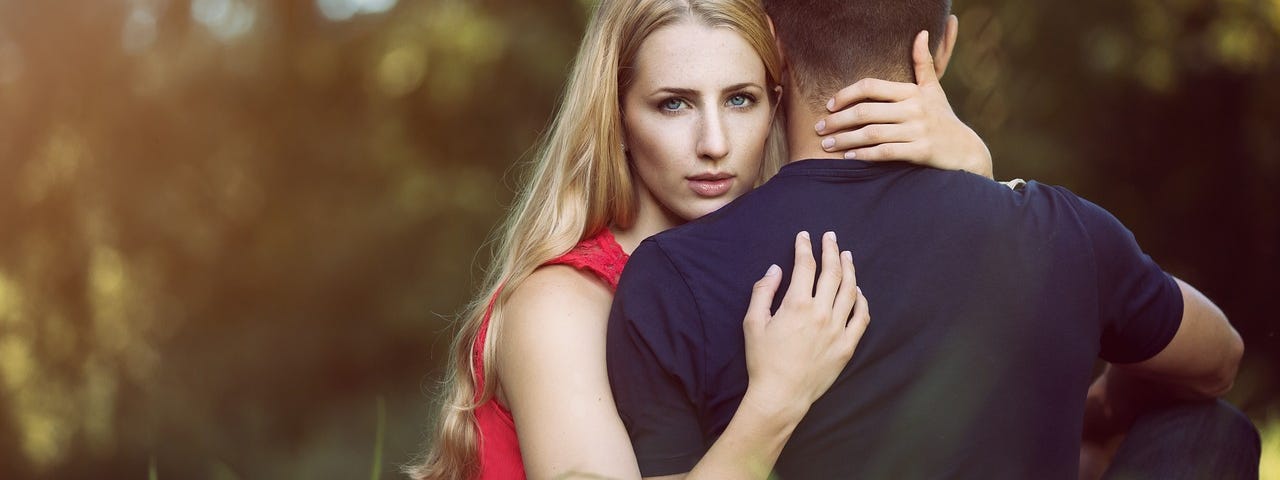 A young woman hugging a man.