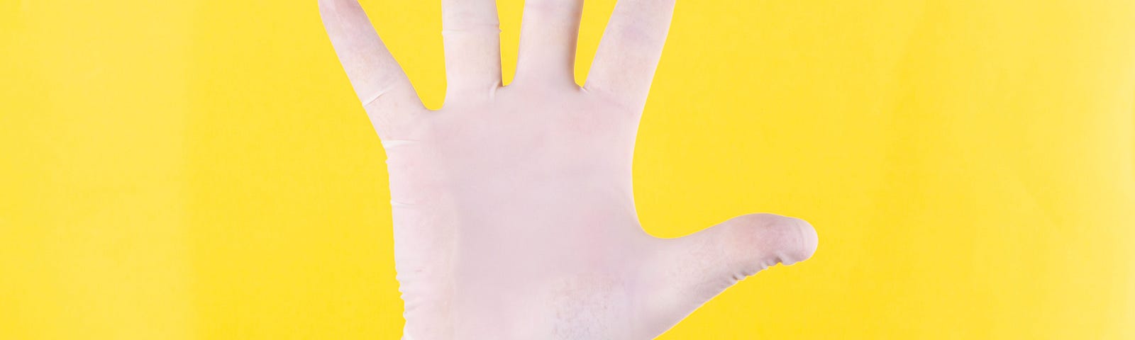 White glove on yellow background