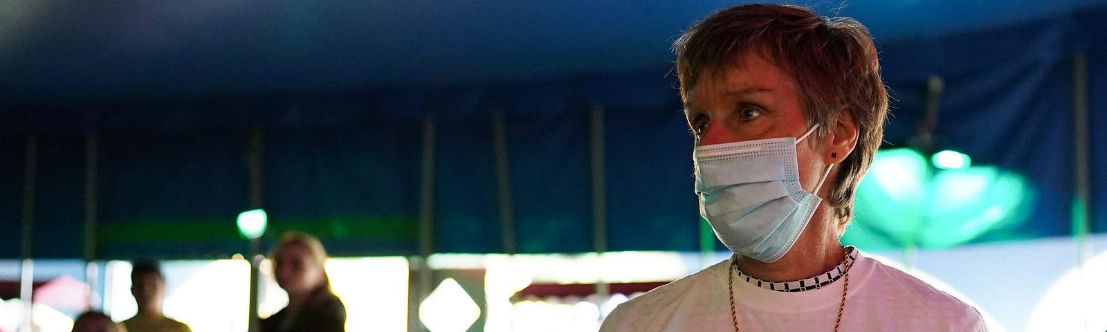 Woman wearing a mask and T-shirt that reads “I’ve had the vaccine -- talk to me.”