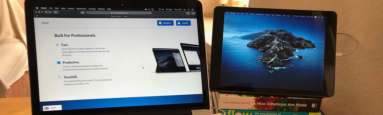 Dual monitor setup with laptop and iPad placed on a pile of 4 books, connected via Duet Display app.