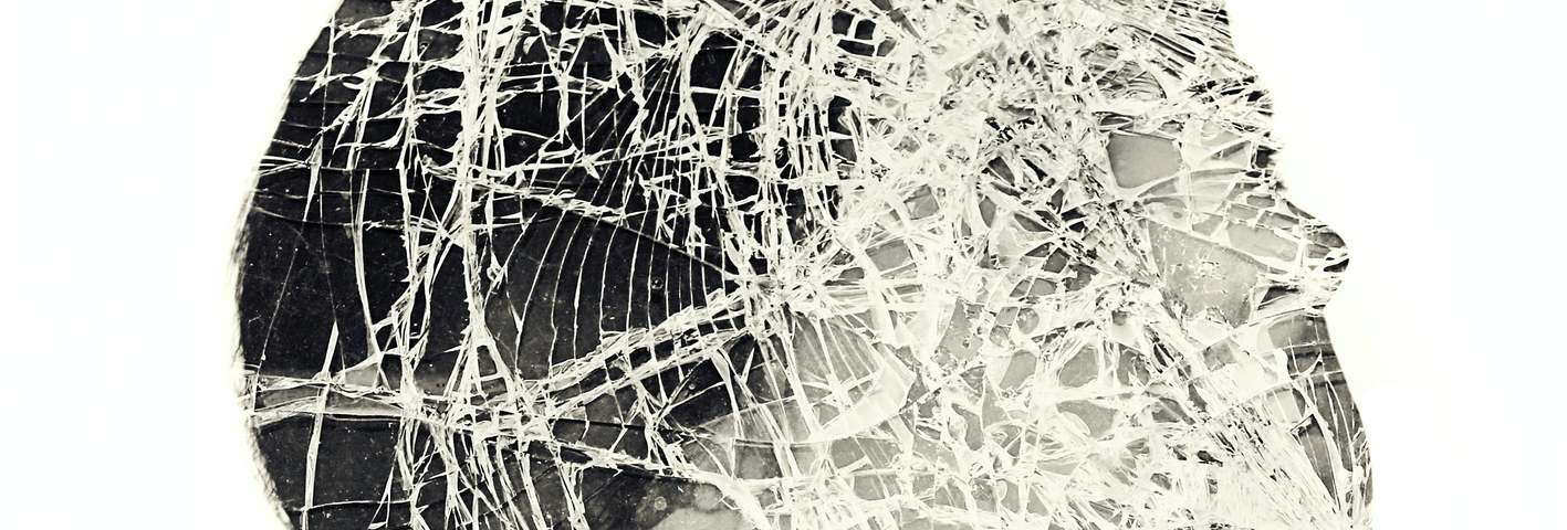 A multiple exposure photo of a woman’s face that appears to be shattered.