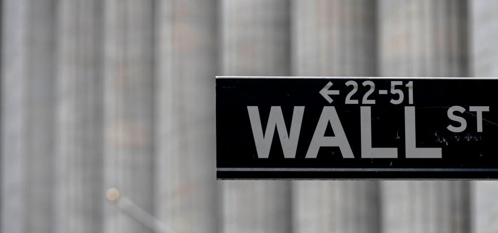 Closeup of Wall Street sign post in New York City.