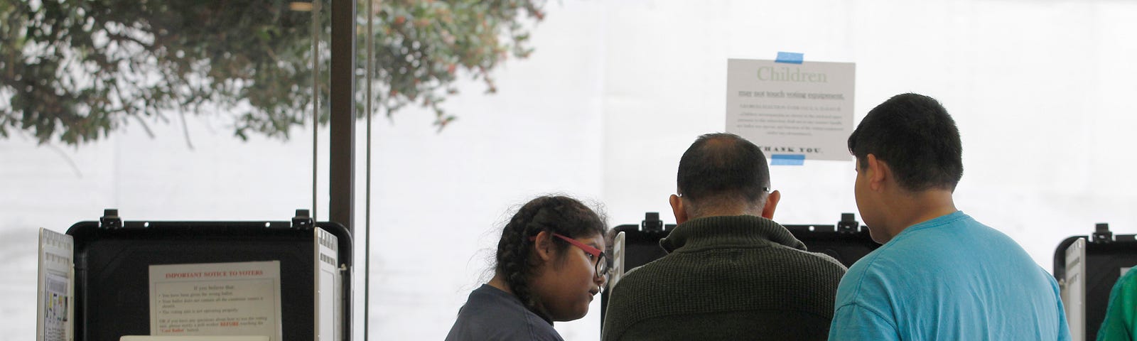 A voter’s children observe as he votes in the 2016 U.S. Presidential election in Athens, Georgia.