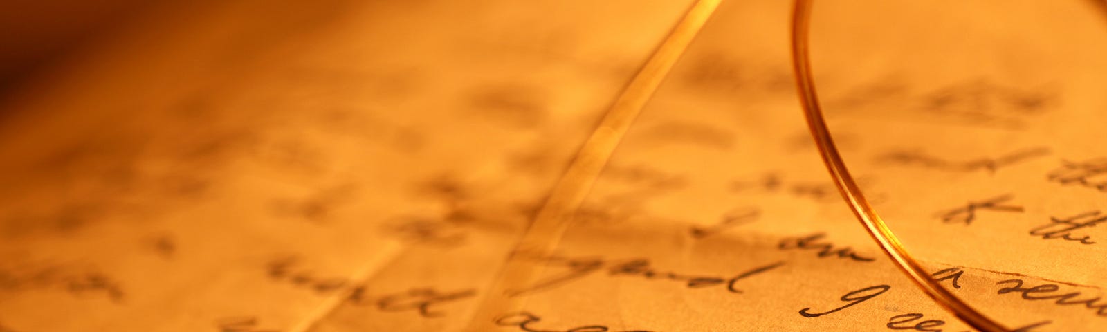 Closeup of glasses on a page scribbled with words.