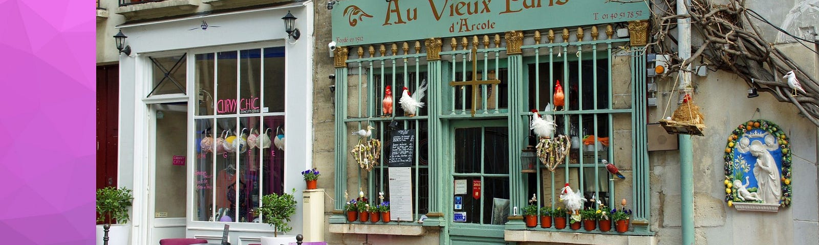 The colorful seagreen and magenta streetscape outside Au Vieux Paris d’Arcole restaurant in central Paris.