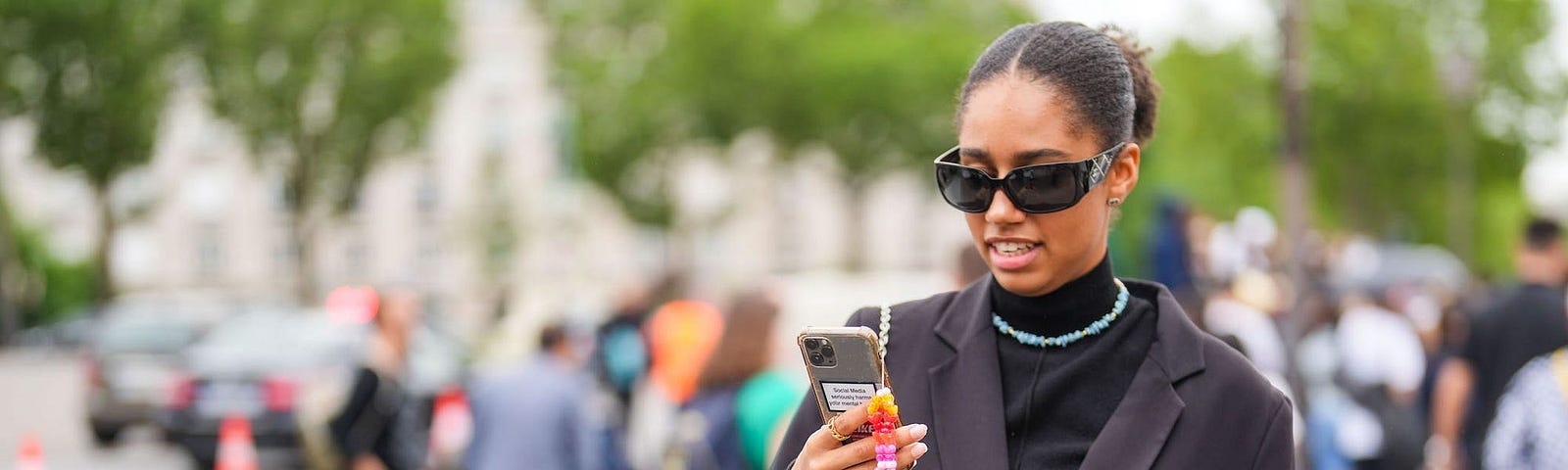 A woman using her phone outside.