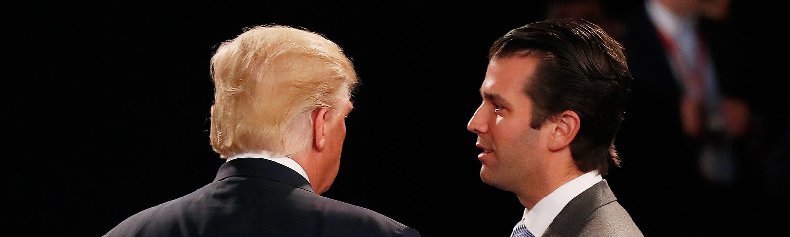 Donald Trump, Jr. greets his father Donald Trump during the 2016 town hall debate at Washington University.