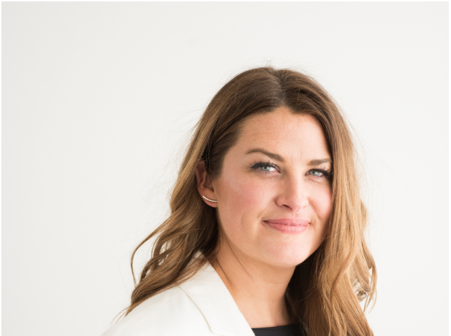 A portrait photo of Christina Stembel, CEO of Farmgirl Flowers, in a white blazer.