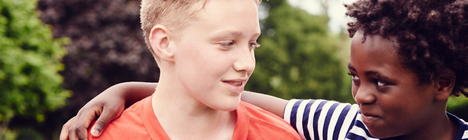 Portrait of a black boy standing with a white boy.