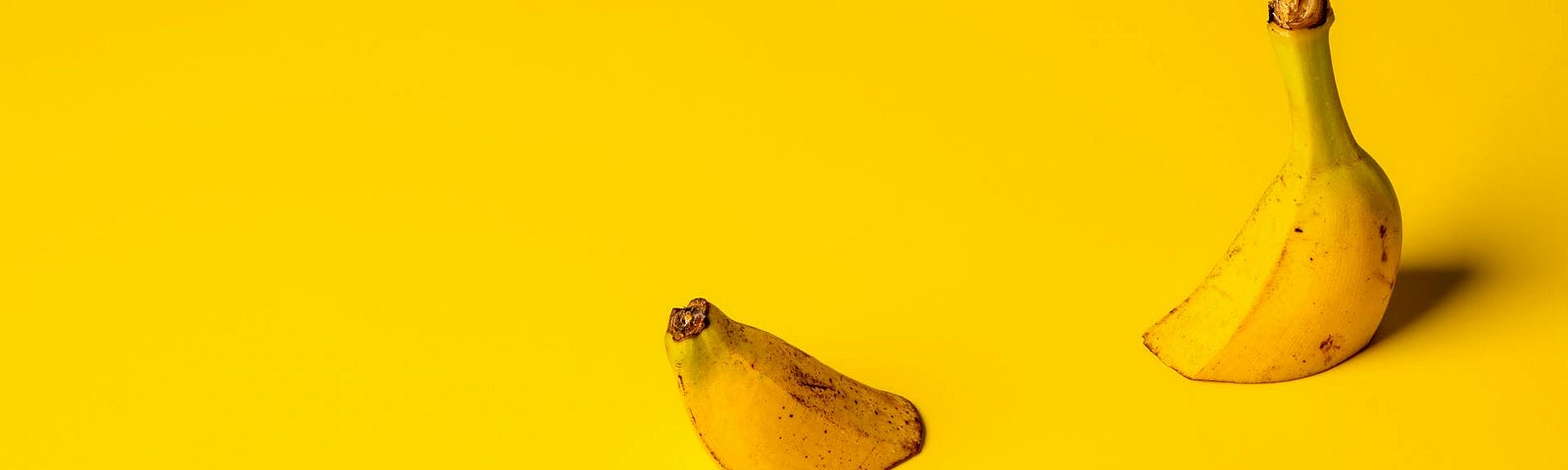 a banana submerged on a yellow background with the 2 ends protruding