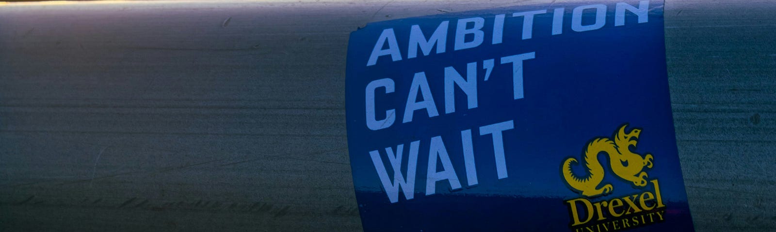Picture of Drexel University’s slogan “Ambition Can’t Wait” with the Philadelphia Skyline in the background