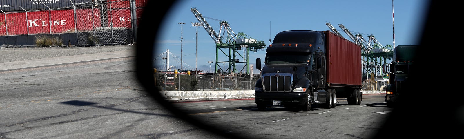 A truck loaded with a shipping container drives through the Port of Oakland on September 03, 2019 in Oakland, California.