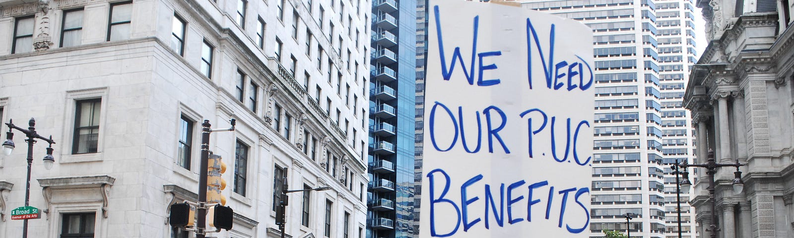 People with picket signs attend a rally in Philadelphia.