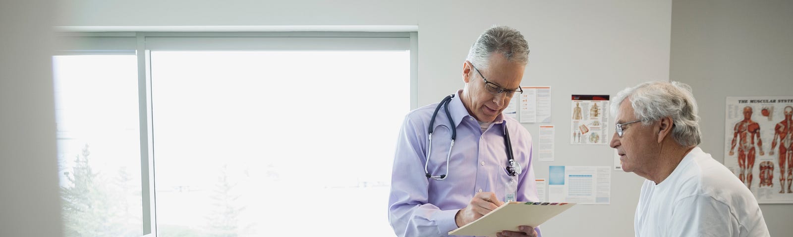 A doctor reviews the medical chart of a senior male patient.