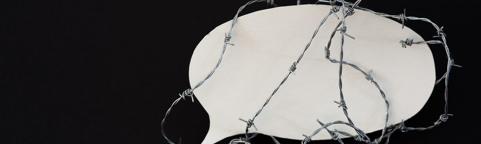 Barbed wire around a speech bubble