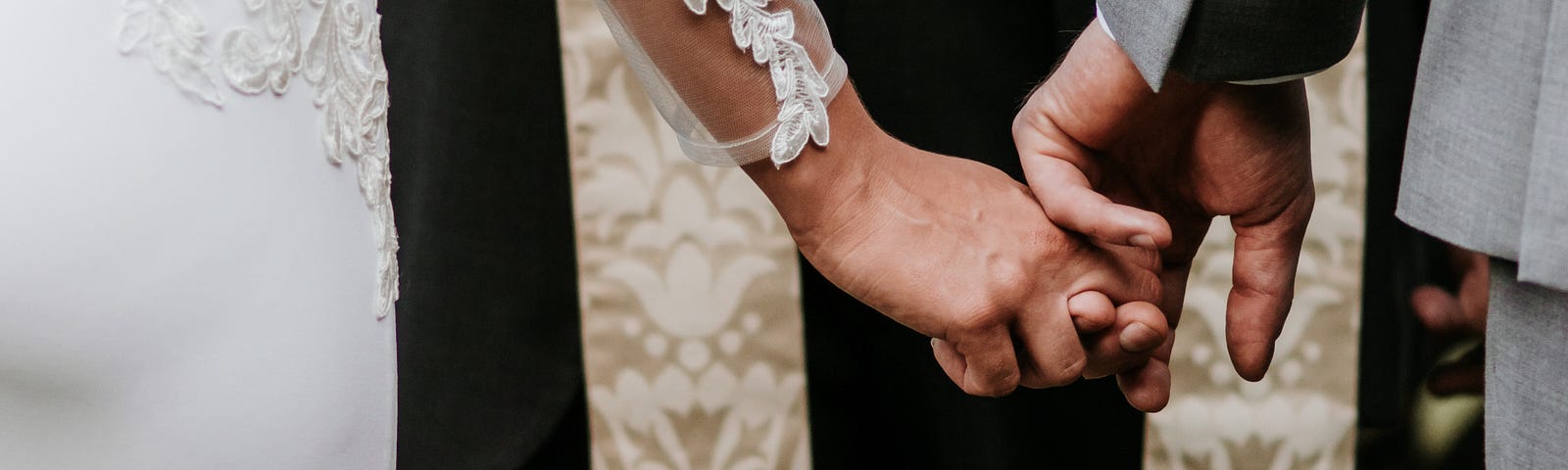 A picture of a couple getting married by a priest.