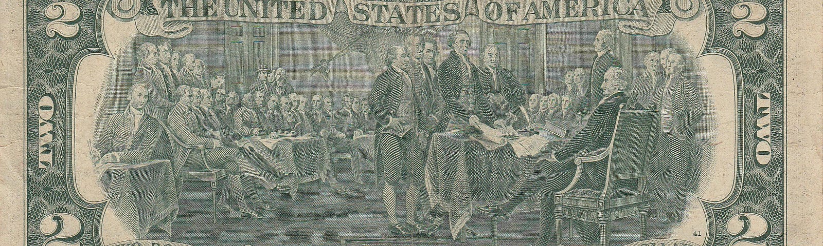Reverse side of the most recent design of the US two dollar bill, showing the engraving of the signing of the Declaration of Independence.