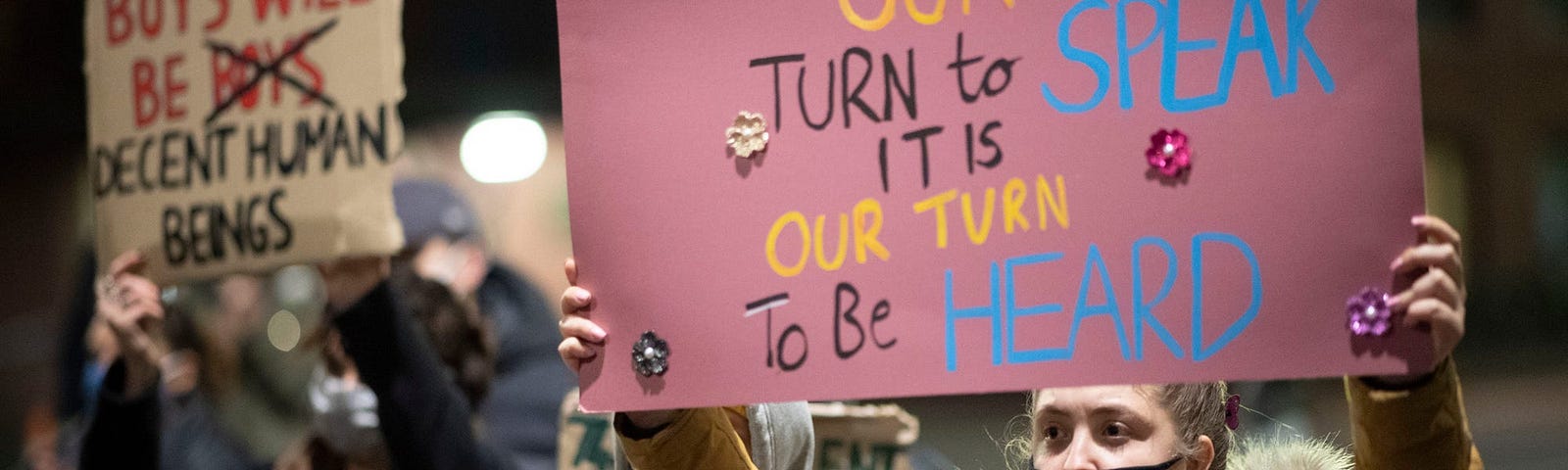 A protestor holds up a sign during a protest outside Cardiff Bay police station on March 15, 2021 in Cardiff, Wales.