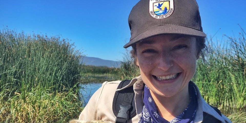 Jesy Simons, FWS Scholar and Wildlife Biologist, with a duckling at Lower Klamath National Wildlife Refuge.
