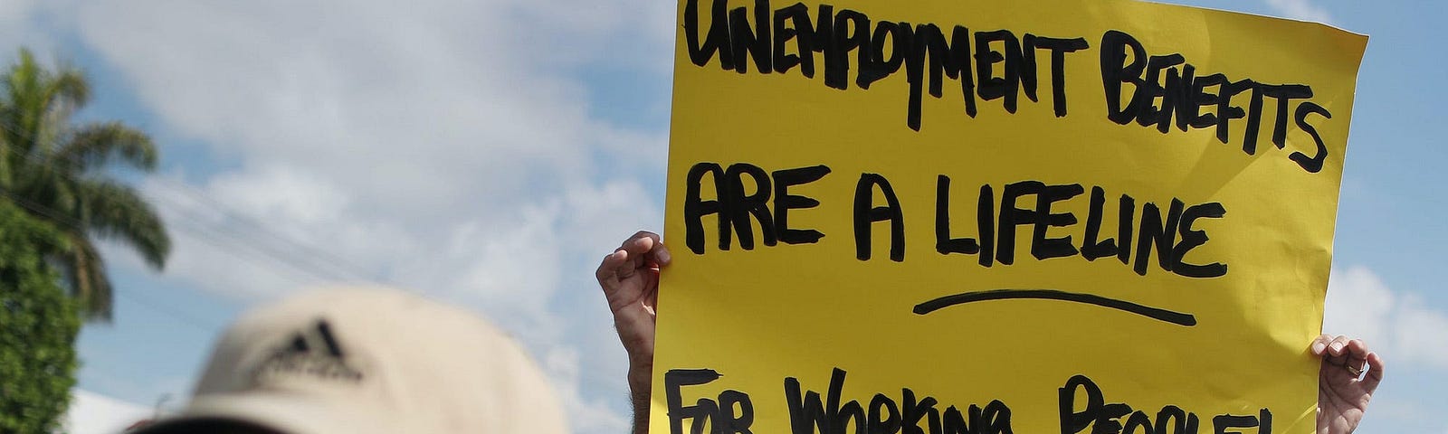 Carlos Ponce joins a protest asking senators to continue unemployment benefits past July 31, 2020 in Miami Springs, Florida.