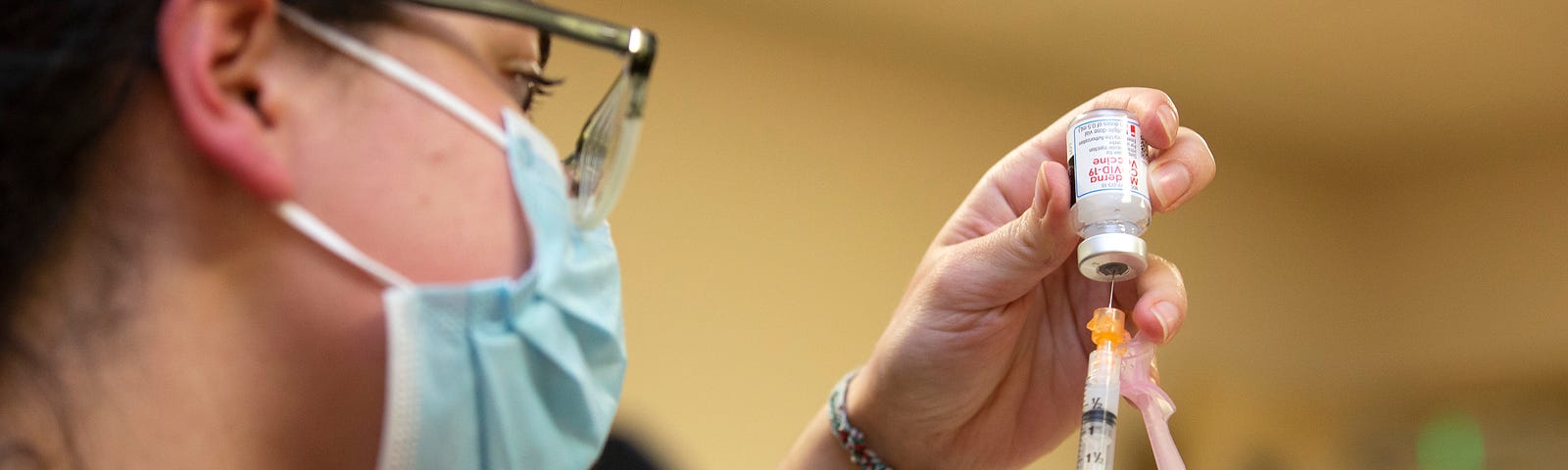 A female clinical pharmacist with Seattle Indian Health Board (SIHB) administers a shot of the Moderna COVID-19 vaccine, to frontline workers at the SIHB on December 21, 2020 in Seattle, Washington.