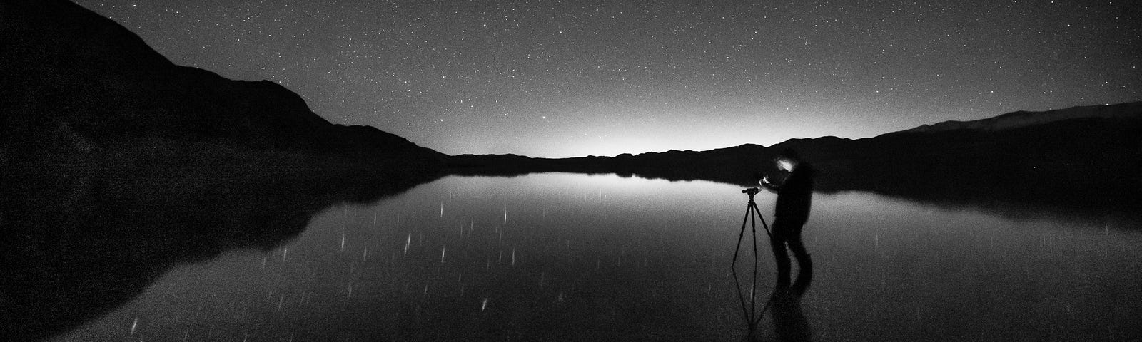 A fellow friend and photographer stands in temporary Lake Manly, Death Valley, as we work together to photograph the stars and Milky Way in early morning.