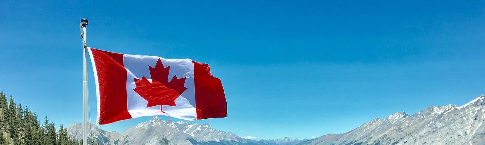 Canada Flag With Mountain Range View