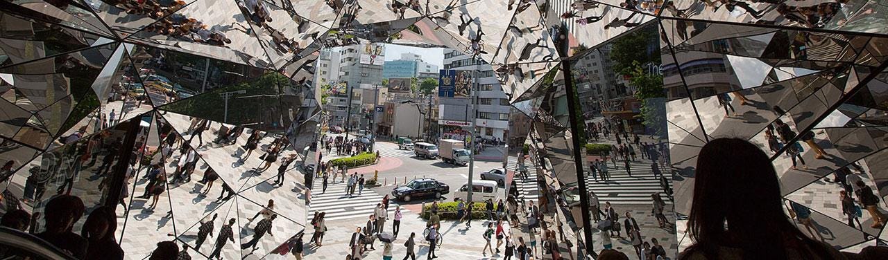Multi-surfaced kaleidoscope-like mirrored entrance at OmoHara shopping center in Tokyo.