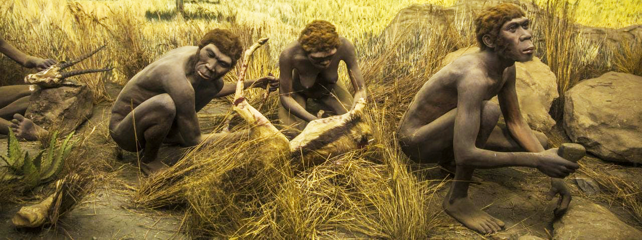 Early hominins butchering food on the savannah.